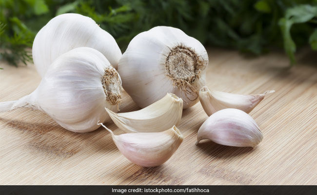 Eating fresh, raw garlic is one among the herbal remedies for controlling high blood pressure.