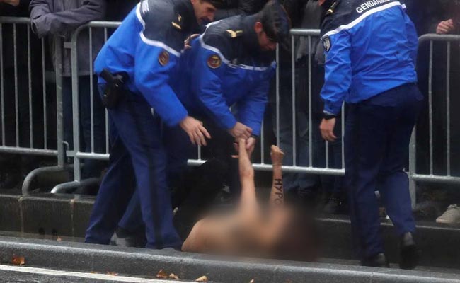 Topless Female Protester Runs At Trump's Motorcade In Paris