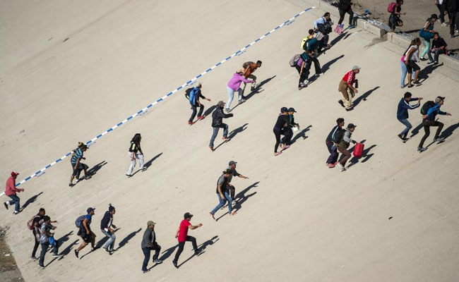 US Border Post Reopens, Tear Gas Fired As Migrants Flee From Mexico