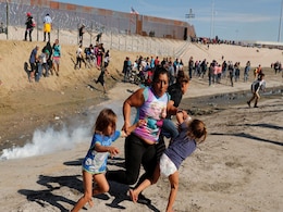 Honduran Migrant Clutches 2 Children, Flees Tear Gas At US-Mexico Border Honduran Migrant Clutches 2 Children, Flees Tear Gas At US-Mexico Border