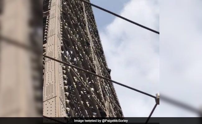Eiffel Tower locked down amid reports man climbs landmark