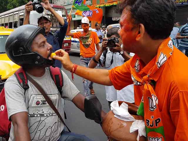BJP Supporters In West Bengal Celebrate With Saffron Rosogollas