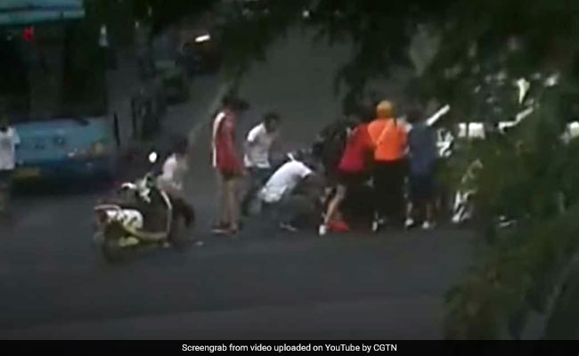 Watch: Passersby Lift Minibus To Rescue Woman Pinned Underneath