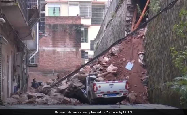 Woman's Narrow Escape As Wall Collapses, Buries Cars