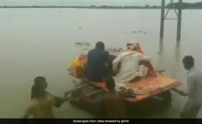 On Video, Newly Married Couple Cross Flooded Road Using Makeshift Boat