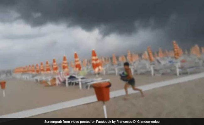 Video: Visitors Flee Beach As Severe Storm Sends Debris Flying