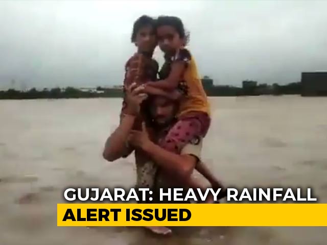 Gujarat Cop Carries 2 Girls Through Waist-Deep Floodwater, Wins Praise