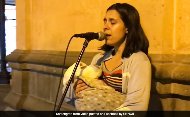 She Sings On A Street In Peru, Rocking Her Baby In Her Arms. It's OK To Cry