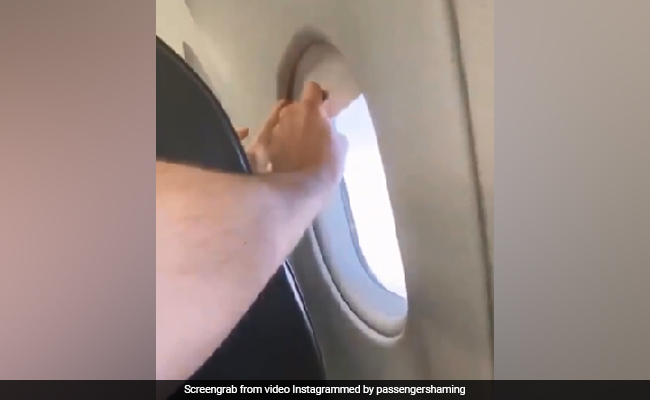 Two Grown Men Fight Over An Airplane Window Shade In This Viral Video