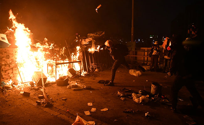 Hong Kong Police Officer Hit By Arrow As Protesters Dig In At Campus
