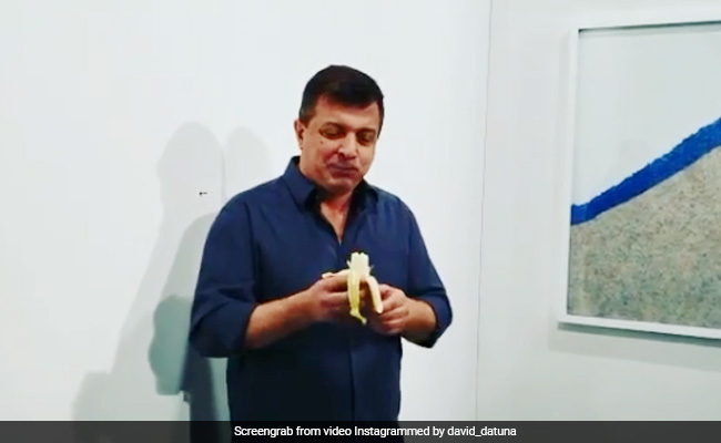 Performance Artist Eats $120,000 Piece Of Art - A Banana Taped To Wall