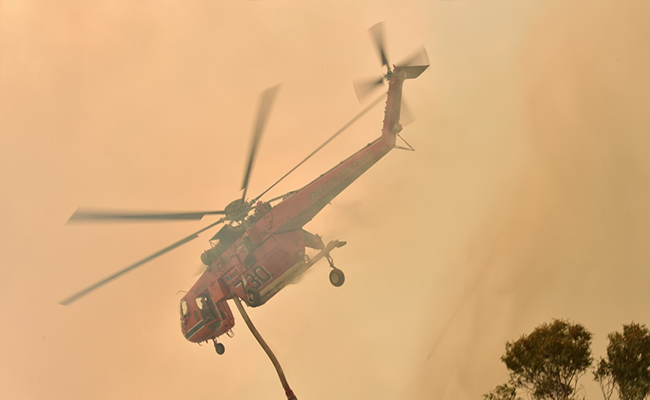 Sky-High Smoke Dwarfs Waterbomber Helicopter In Australia