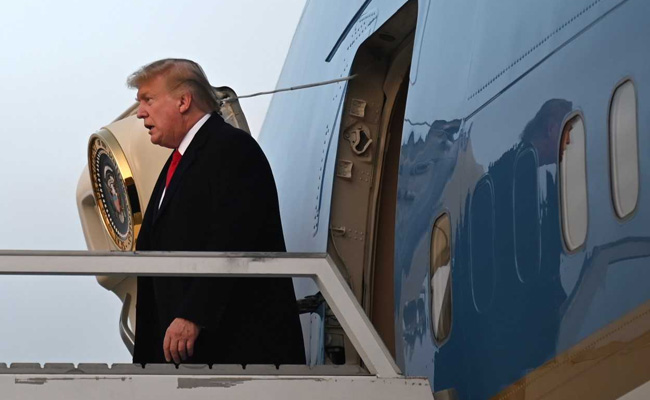 Trump Arrives In Davos Hours Before Impeachment Trial Reopens