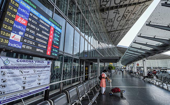 Airline Staff In Protective Gear Wheel Out Passengers At Kolkata Airport
