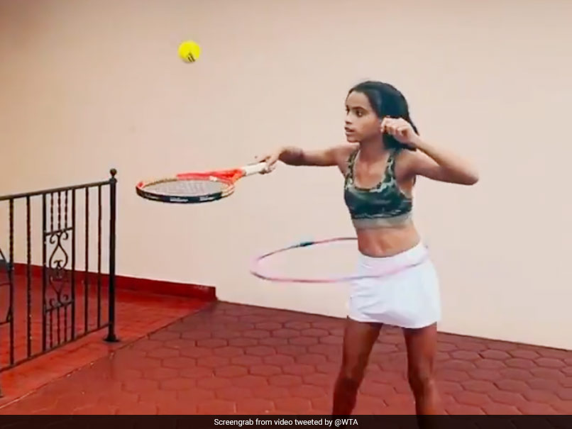 Young Girl Shows Off Tennis Skills While Doing Hula Hoops. Watch