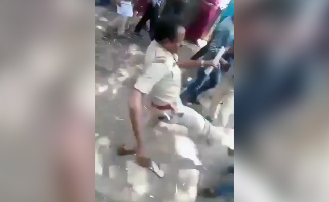 Video Shows Bengaluru Cop Kicking Migrants For Demanding Home Travel