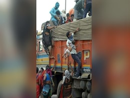 Man Clutches Baby In Scramble To Get On Truck: Story Behind Tragic Image Man Clutches Baby In Scramble To Get On Truck: Story Behind Tragic Image