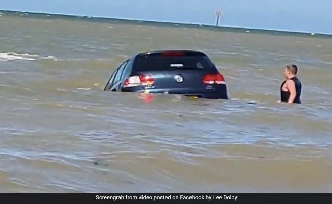 Dramatic Footage Shows Owner Trying To Save Car Swept Away By Sea
