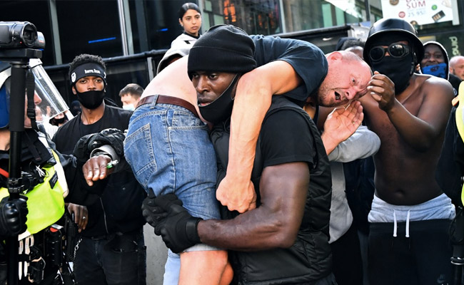 Photo Of Black Man Carrying Injured White Man At London Protests Is Viral