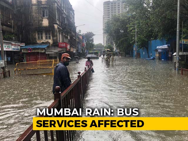 In Mumbai's Parel, People Walk On Road Divider After Rain Floods Road