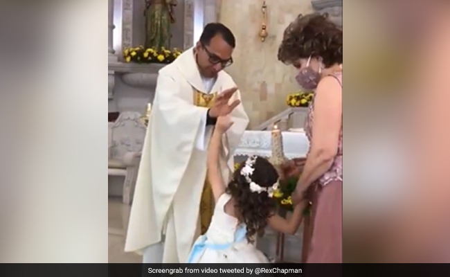Watch: Priest Raises Hand To Bless Little Girl. She High-Fives Him Instead