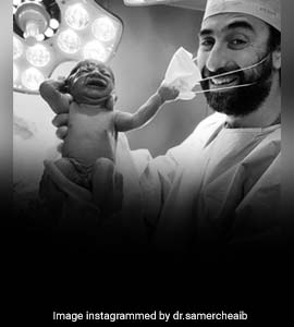 Viral Pic Of Baby Removing Doctor's Mask Becomes Symbol Of Hope