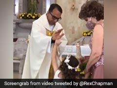 Watch: Priest Raises Hand To Bless Girl. She High-Fives Him Instead