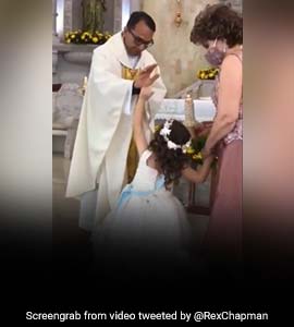 Watch: Priest Raises Hand To Bless Girl. She High-Fives Him Instead