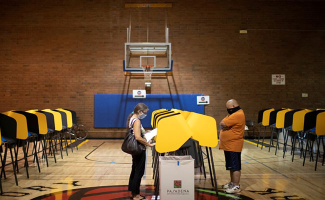 Americans Brace For Election Day With Faces Masked, Stores Boarded Up