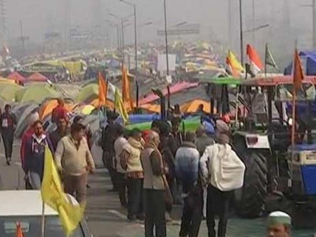 Protesters Climb On Top Of Police Vehicle At Delhi's Mukarba Chowk