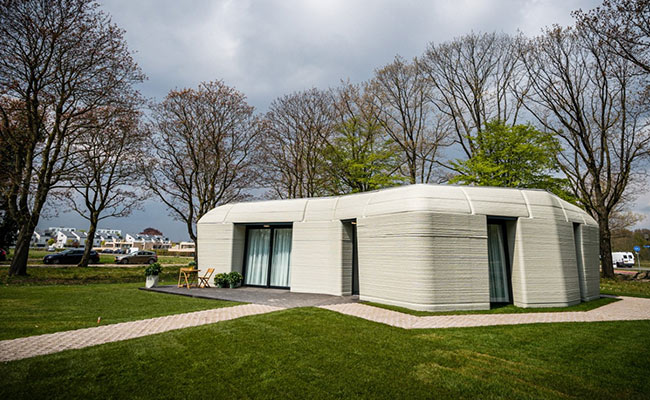 This 3D-Printed House, Shaped Like A Boulder, Just Got Its First Tenants