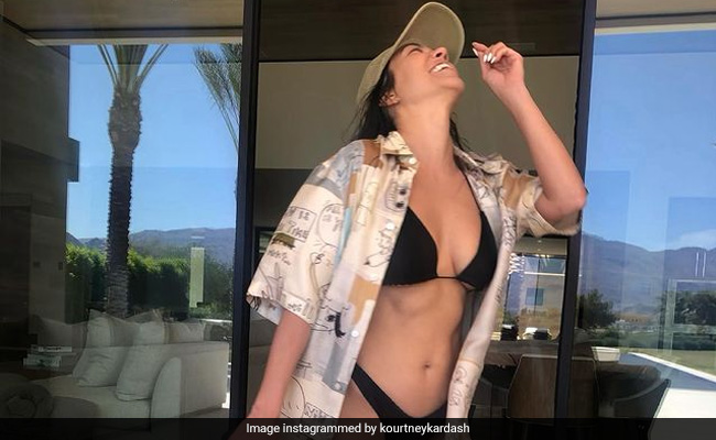 Kourtney Kardashian Gives Her Black Bikini A Touch Of The Wild West With Cowboy Boots
