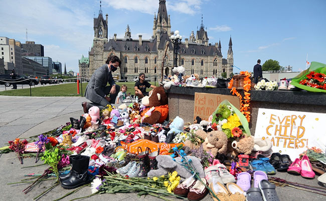 Justin Trudeau Lays Flowers At Makeshift Memorial For Indigenous Students