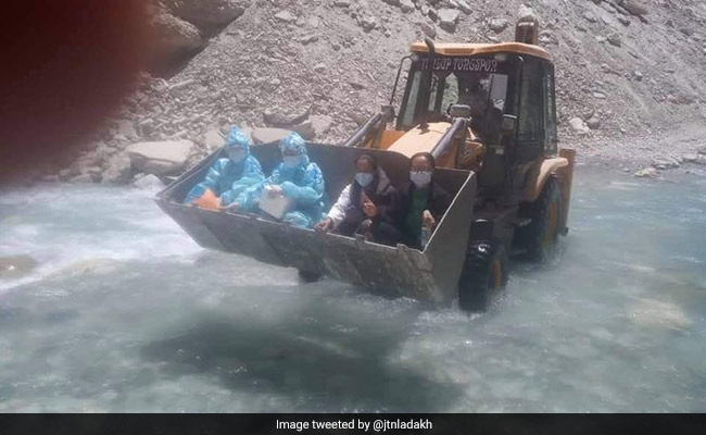 Internet Applauds COVID-19 Warriors Crossing A Ladakh River In An Earth Mover