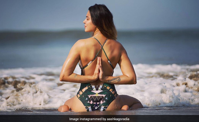 Aashka Goradia Is Turning Heads With Beach Yoga In A Stunning Printed Swimsuit