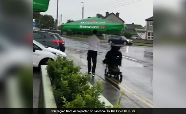 Watch: Cafe Worker Helps Wheelchair-Bound Patron Get Home In Pouring Rain