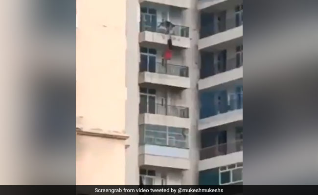 Video: Man Holds On To Woman Hanging From Balcony. She Falls, Survives