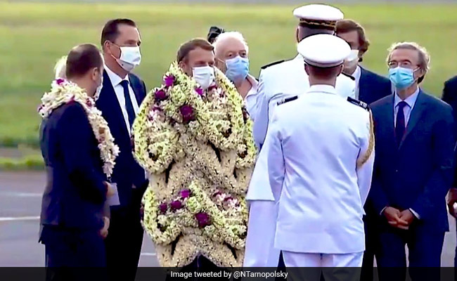 Truth Behind Viral Pic Of French President Emmanuel Macron Covered In Garlands