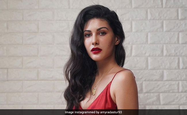 Roses Are Red And So Is Amyra Dastur In Stunning Red Satin Gown With A Flower In Her Hand