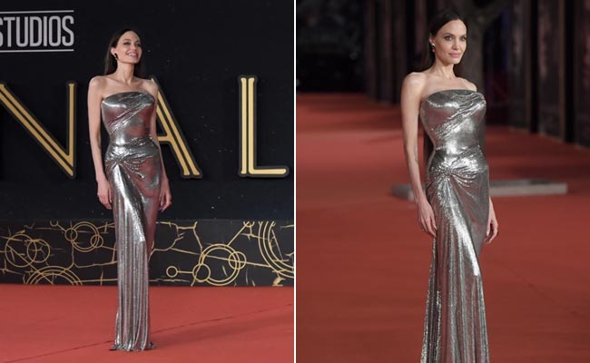 The Spotlight Shines Brighter On Angelina Jolie In A Stunning Silver Strapless Versace Gown