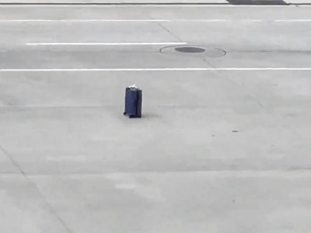 Unattended Luggage Rolls Down Airport Ramp