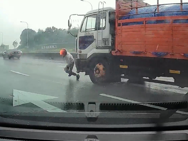 Motorcyclist Nearly Run Over After Crashing on Highway