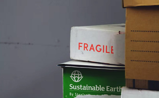 Video Captures Courier Driver Launching Parcel Over 10-Feet Fence, Leaving It Smashed On Pavement