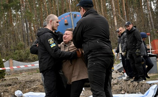 "My Little Son":Ukraine Woman Weeps By Grave On Route Of Russian Retreat