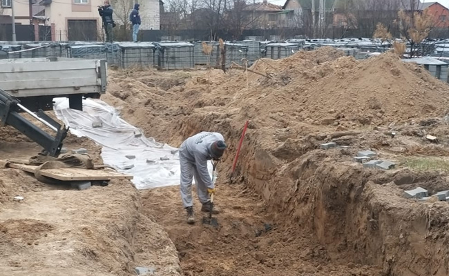 French Police Officers Probe Bucha Mass Grave In Ukraine
