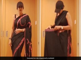 Here's The Ingenious Reason Mandira Bedi Is Draping Her <i>Saree</i> While Wearing A Cap Here's The Ingenious Reason Mandira Bedi Is Draping Her <i>Saree</i> While Wearing A Cap