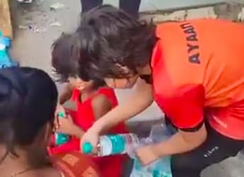 Young Boy Distributes Water Bottles To Help People Beat The Heat; Internet Approves Young Boy Distributes Water Bottles To Help People Beat The Heat; Internet Approves