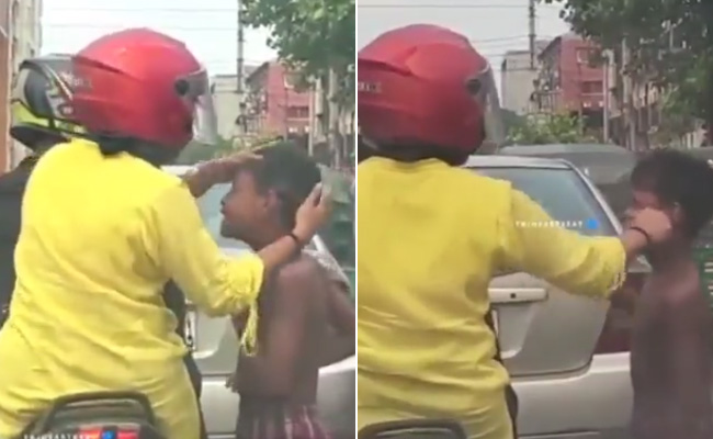 ट्रैफिक सिग्नल पर बच्चे की मदद के लिए आगे आई महिला, Video देख पिघल जाएगा दिल