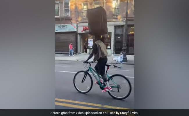 "I Got It": Brooklyn Cyclist Balances Suitcase On His Head