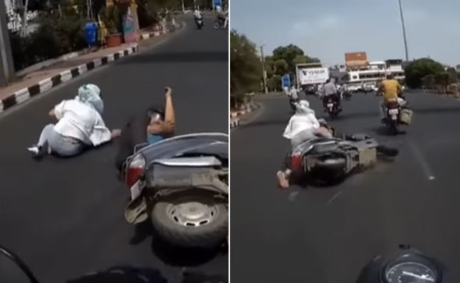 स्कूटी से अपने आप गिरी महिला ने पीछे आ रहे बाइक सवार पर लगाया आरोप! वायरल हो रहा Video
